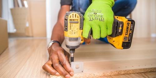 man drilling wood